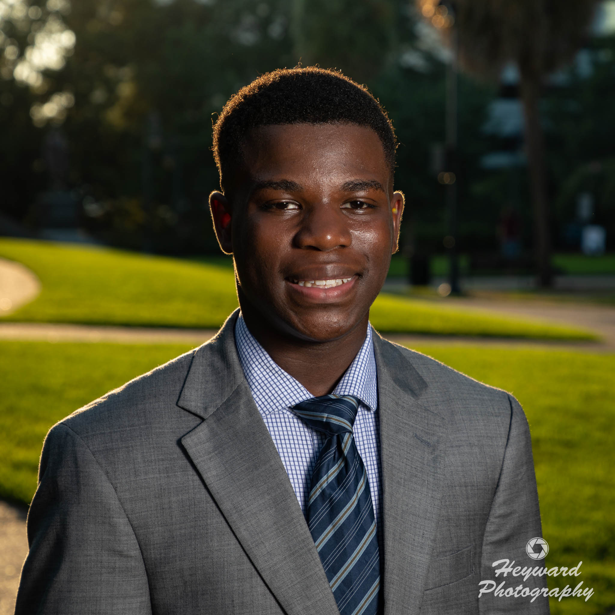 Young black man posing for a picture.