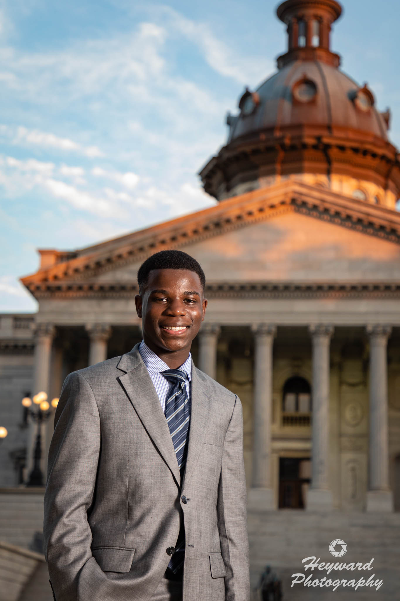 Young black man posing in front of SC Statehouse.